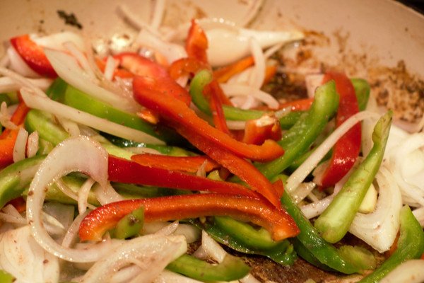 After browning the steak, lightly saute the vegetables. Then add wine to deglaze the pan, and begin the sauce.