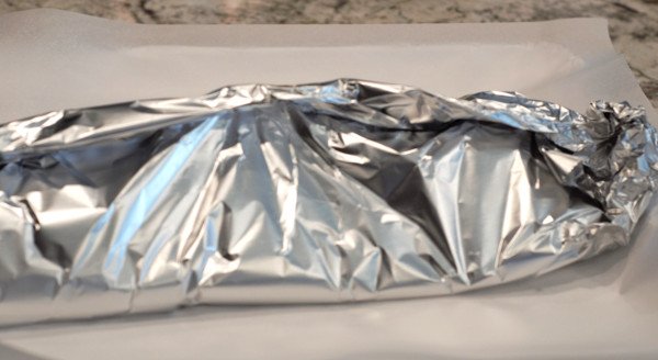Lay a large piece of foil down under the rack of ribs, and fold around to create a pouch.