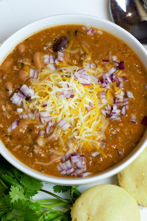 Overhead shot of chili topped with cheese and onions