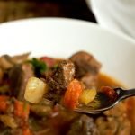 Celery, Carrots, Potato, Tomato, and tender Beef all on the fork to make a perfect bite of Instant Pot Stew.