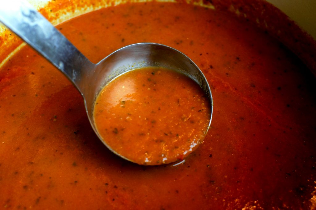 Ladle full of tomato-basil-bisque