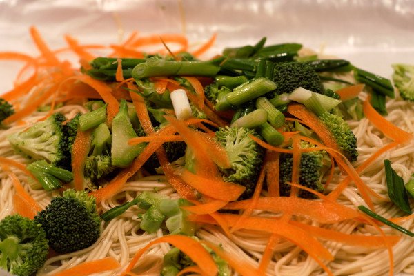 Broccoli, and green onions cut into 1" pieces, and shaved carrots sit on top of our perfectly cooked noodles.