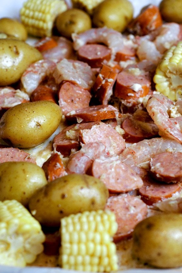 Shrimp, Sausage, Corn, and Potatoes drenched in butter, garlic and Old Bay seasoning. The potatoes are parboiled so they will cook perfectly and take the same amount of time as the shrimp.