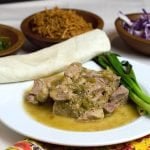 pork on white plate with tortilla