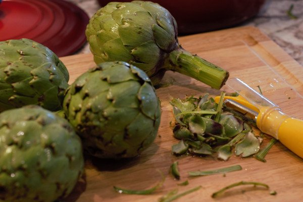Large artichokes with peeled stems and small outer leaves removed.