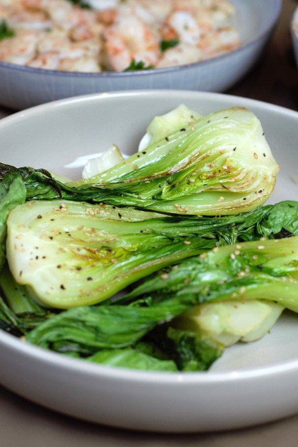 Sesame Grilled Baby Bok Choy drizzled with sesame oil and topped with sesame seeds.