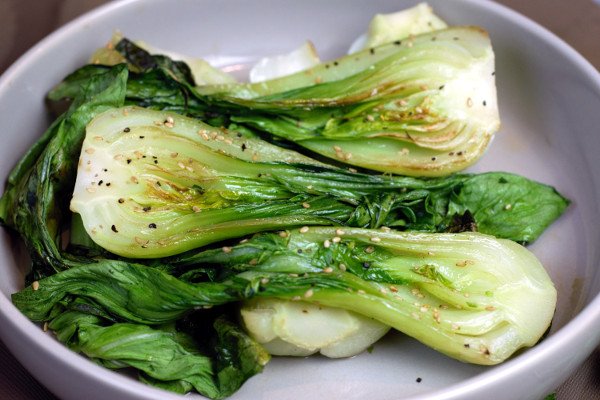 Sesame Grilled Baby Bok Choy drizzled with sesame oil and topped with sesame seeds.