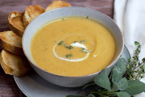 Butternut squash soup surrounded by bread and sage