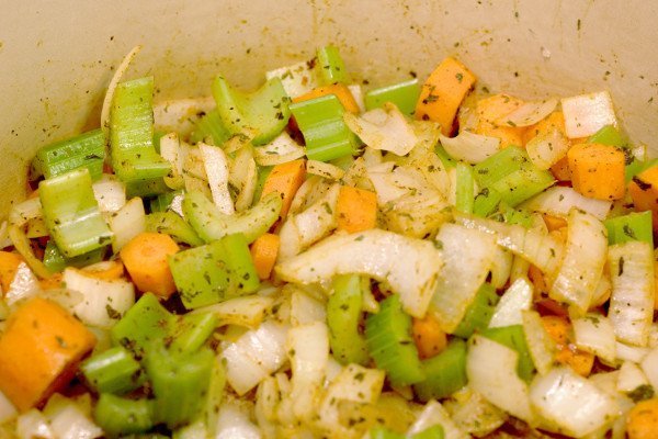 chopped carrots, onion, and celery in the pot with olive oil and spices.