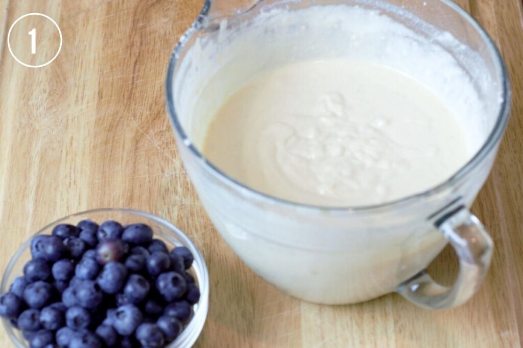 pancake batter in glass bowl, blueberries on the side