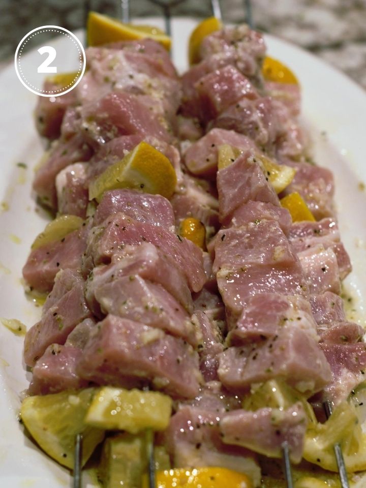 Skewered pieces of pork and lemon