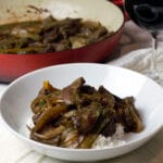 easy peppers steak over rice in a white bowl