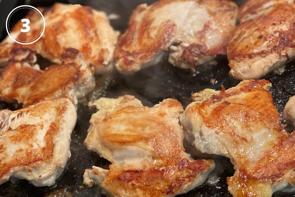 browned chicken thighs in pan