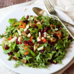 pickled beet salad with dressing on white plate