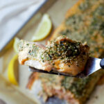 close up piece of salmon filet fully cooked on spatula