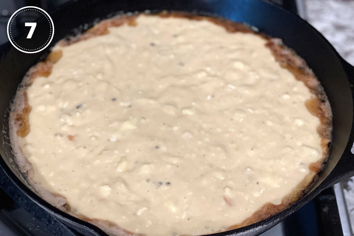 upside down pear cake batter in a cast iron skillet