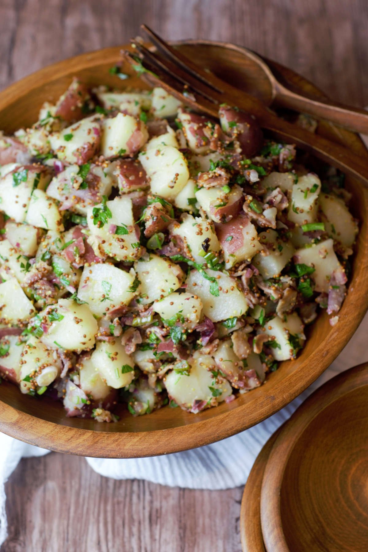 overhead shot of potato salad in wooden salad bowl