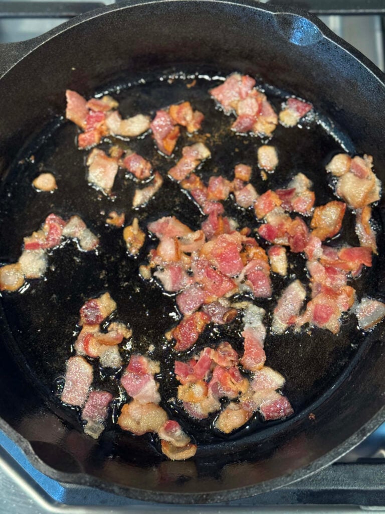 bacon pieces in a cast iron skillet