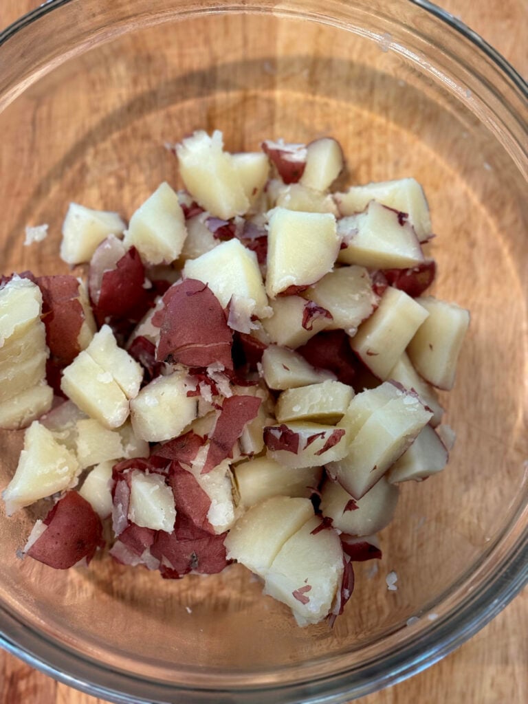 cubed boiled red potatoes in a glass bowl