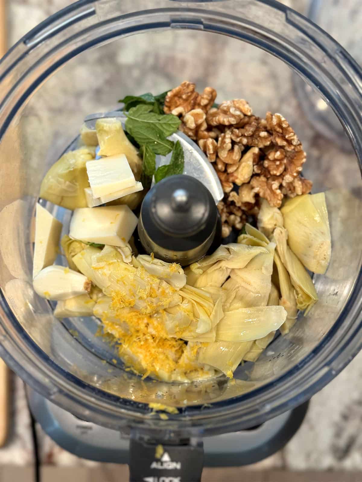 ingredients for artichoke pesto in food processor bowl