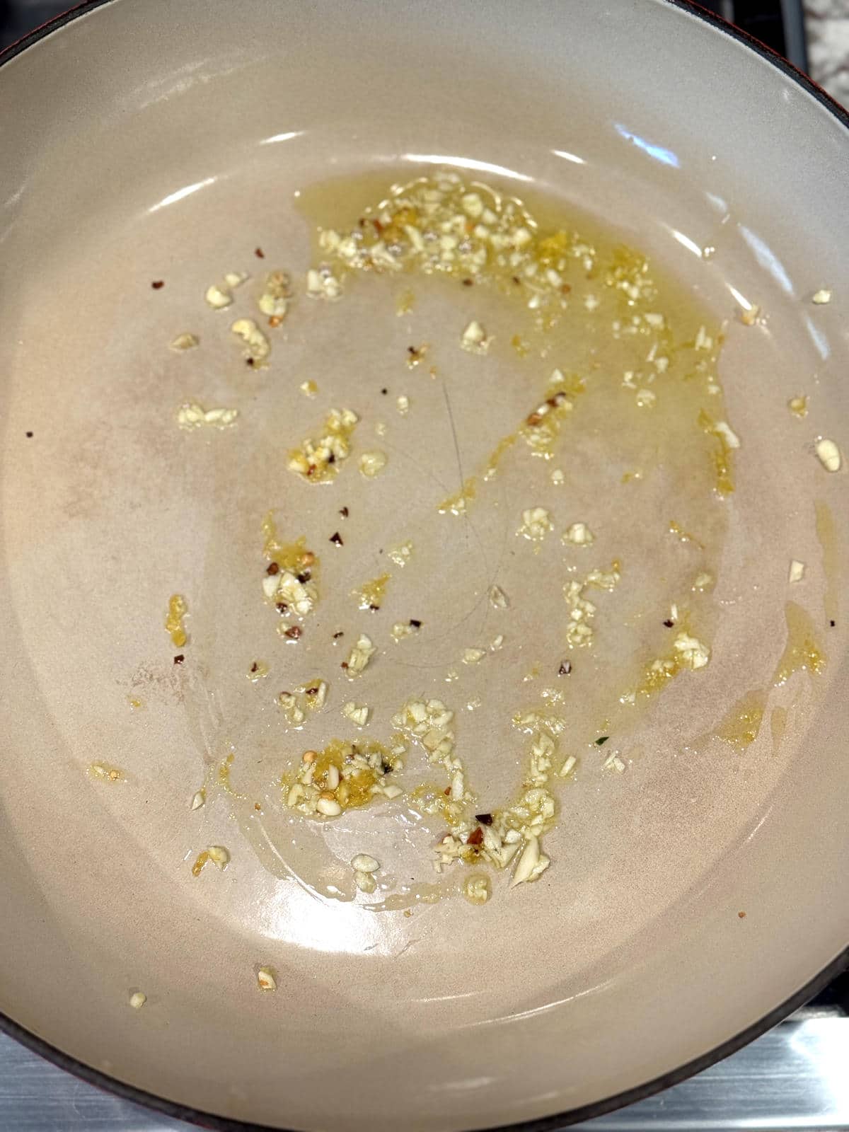 garlic, chili flakes, and lemon zest warming with olive oil in a pan
