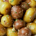 close up browned boiled potatoes in white bowl
