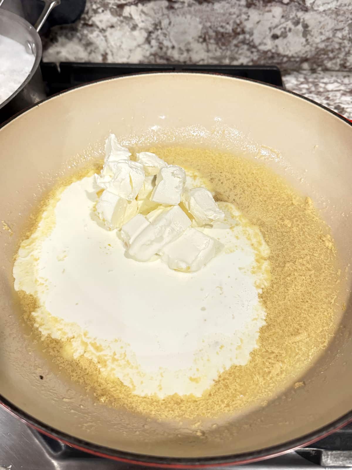 melted butter, cheese, and cream in pan