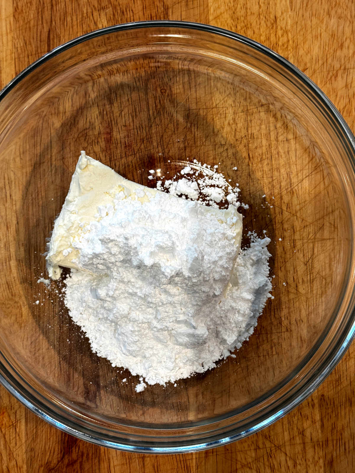 softened cream cheese and powdered sugar in glass bowl