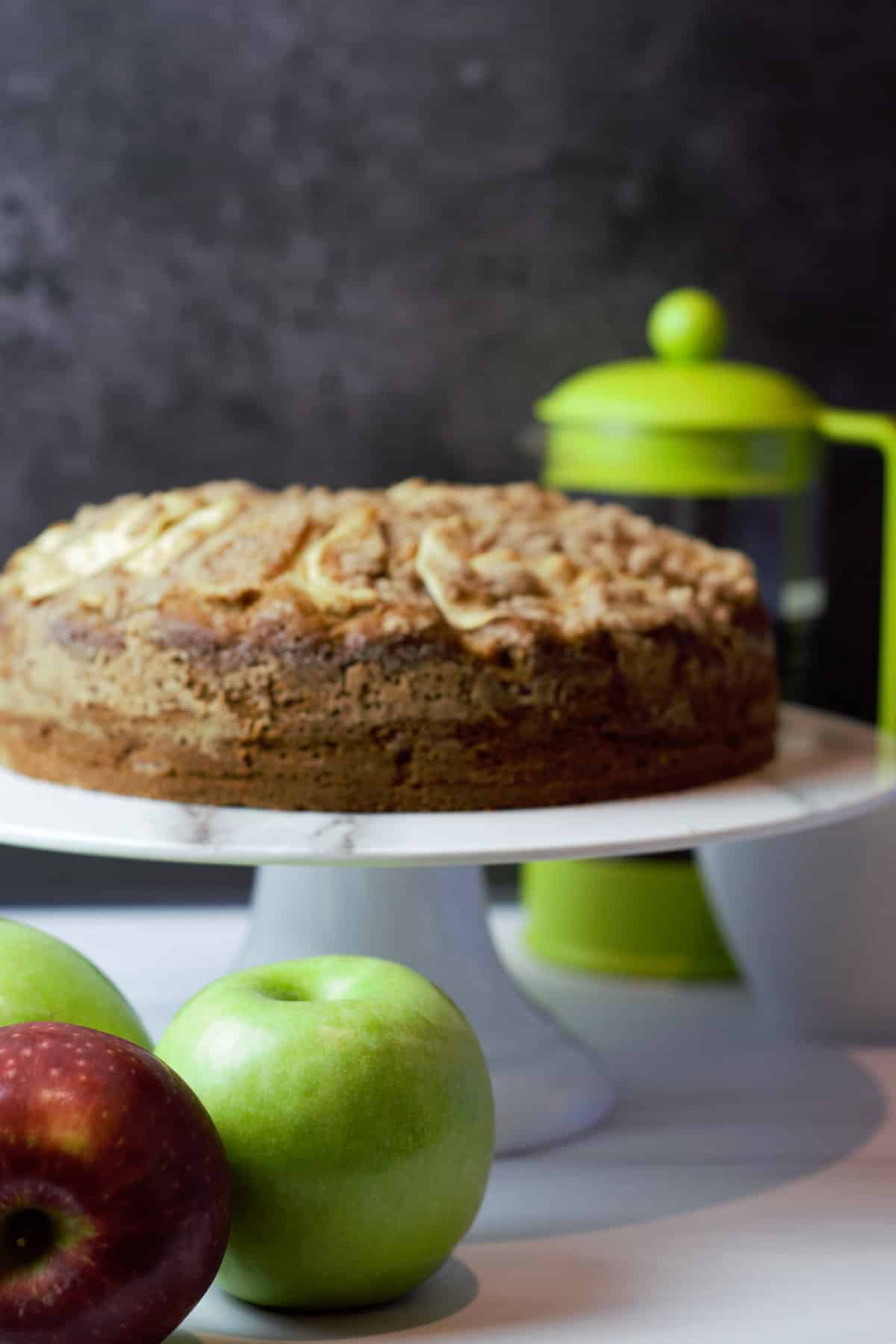 hero close up cake on stand with apples and coffee