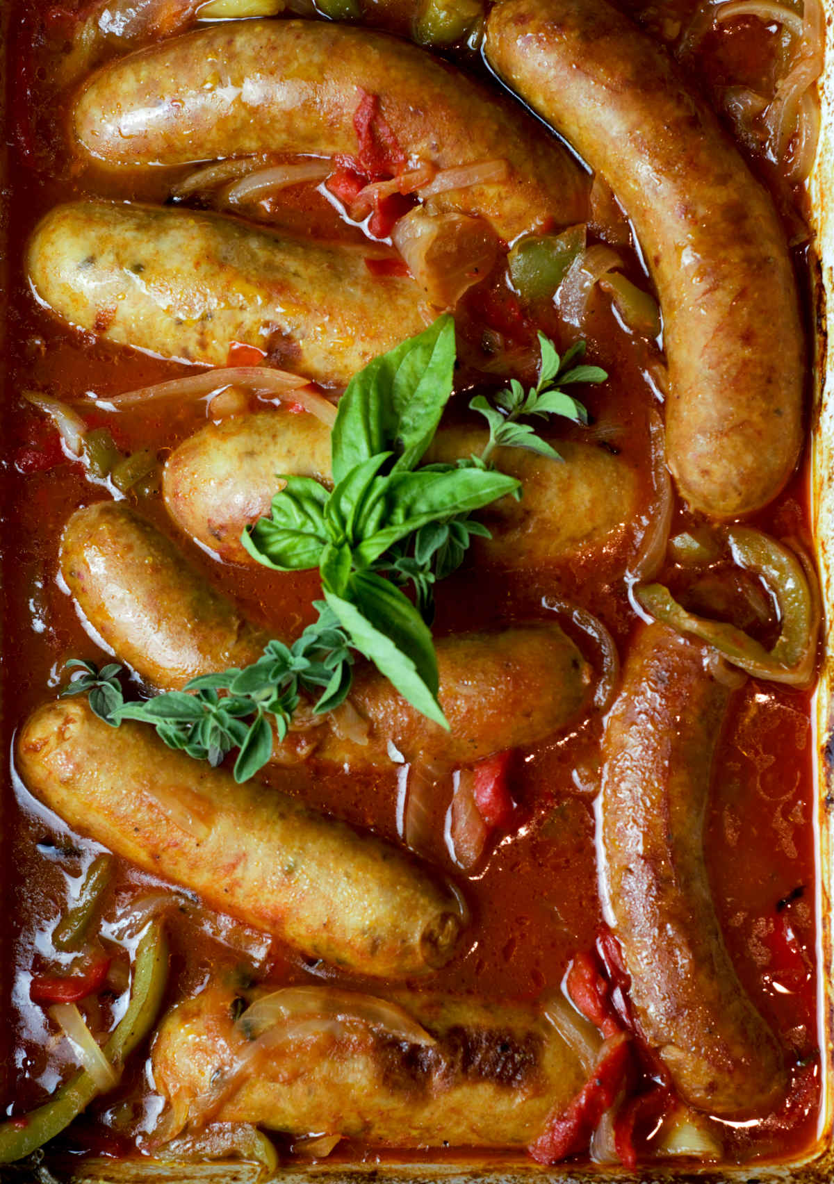 close up of oven baked sausage in pepper and onion sauce